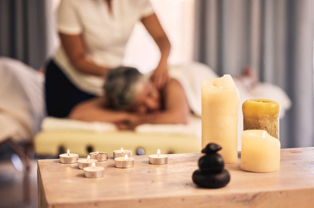 massage spa aroma candles and woman at beauty sal 2023 11 27 05 11 57 utc Large 1024x678