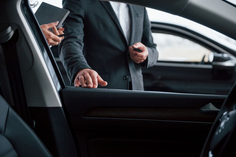 photo from inside vehicle female customer modern stylish bearded businessman automobile saloon