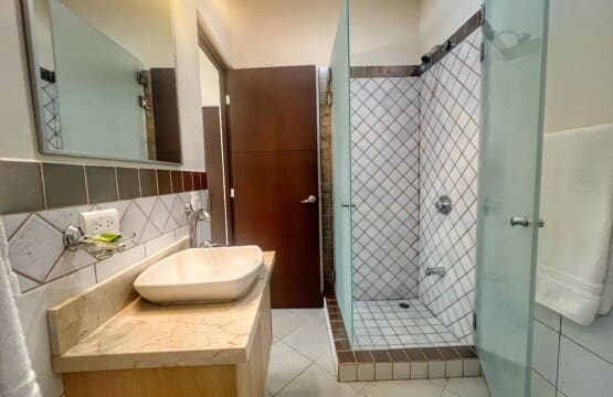 The primary bedroom's ensuite bath includes a large shower stall.