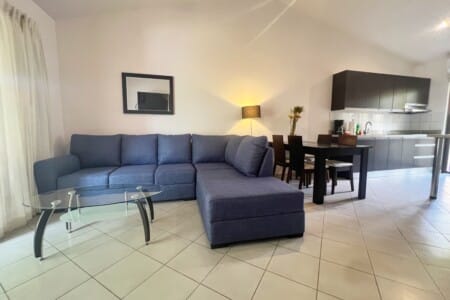 The open concept living/dining/kitchen has a large couch (new in May 2026) and dining for 4.